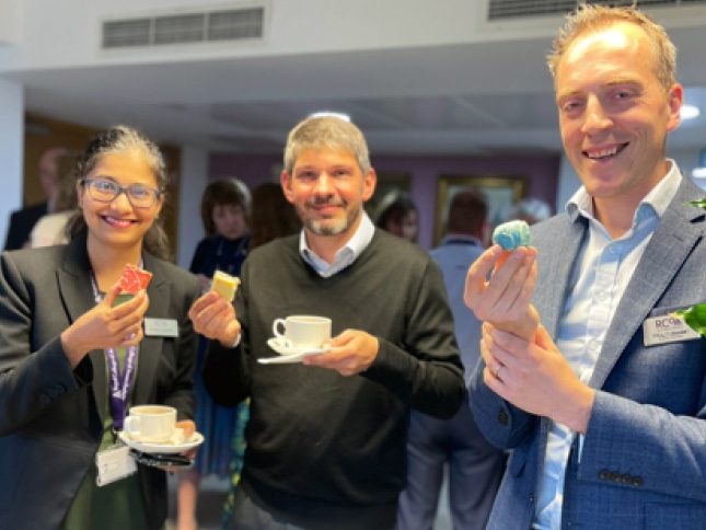 Dr Ashwini Keshkamat with Dr Chris Carey and Dr Jamie Strachan enjoying Diwali sweets over coffee break at a Council meeting.