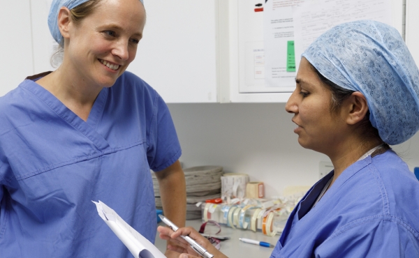 Doctors reviewing documentation on clipboard