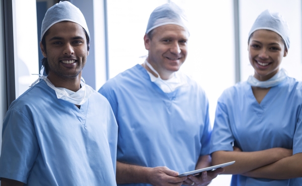 Team of doctors in scrubbs and theatre hats