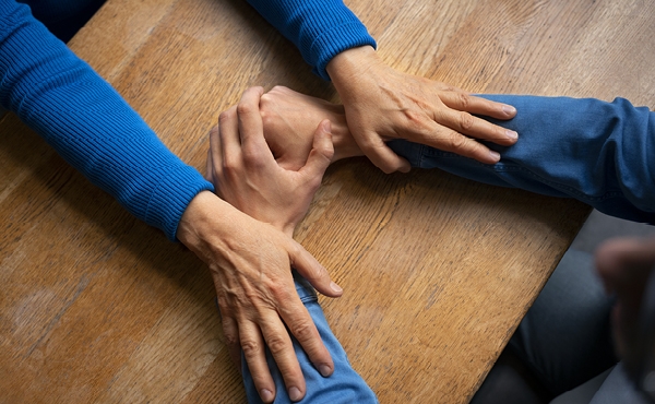 Hands holding each other for support