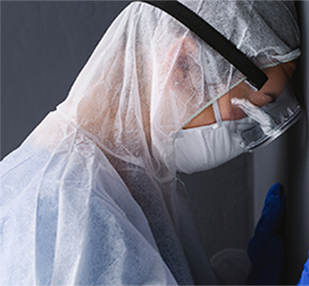 Person in PPE gown and mask